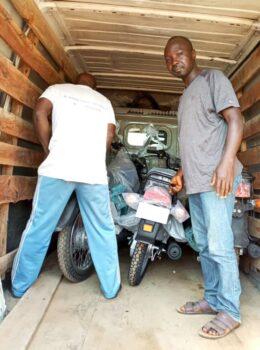 Yerima Timothy (R) stands beside motorcycles delivered to terrorists as part of the ransom for 15 people kidnapped in the town of Kasan-Kogi in February. (Courtesy of Yerima Timothy)