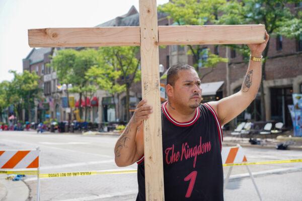 Benny Roberts stands in downtown Highland Park, Ill., on July 5, 2022. (Cara Ding/The Epoch Times)