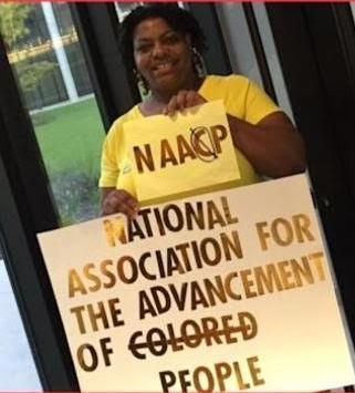 Delia Gray holds her handmade sign, as part of her five-year "one-woman crusade" to get the National Association for the Advancement of Colored People to remove the "C" from the organization's name. (Courtesy of Delia Gray)