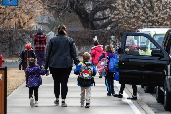 Parents drop their children off for school in Provo, Utah, on Feb. 10, 2021. (George Frey/Getty Images)