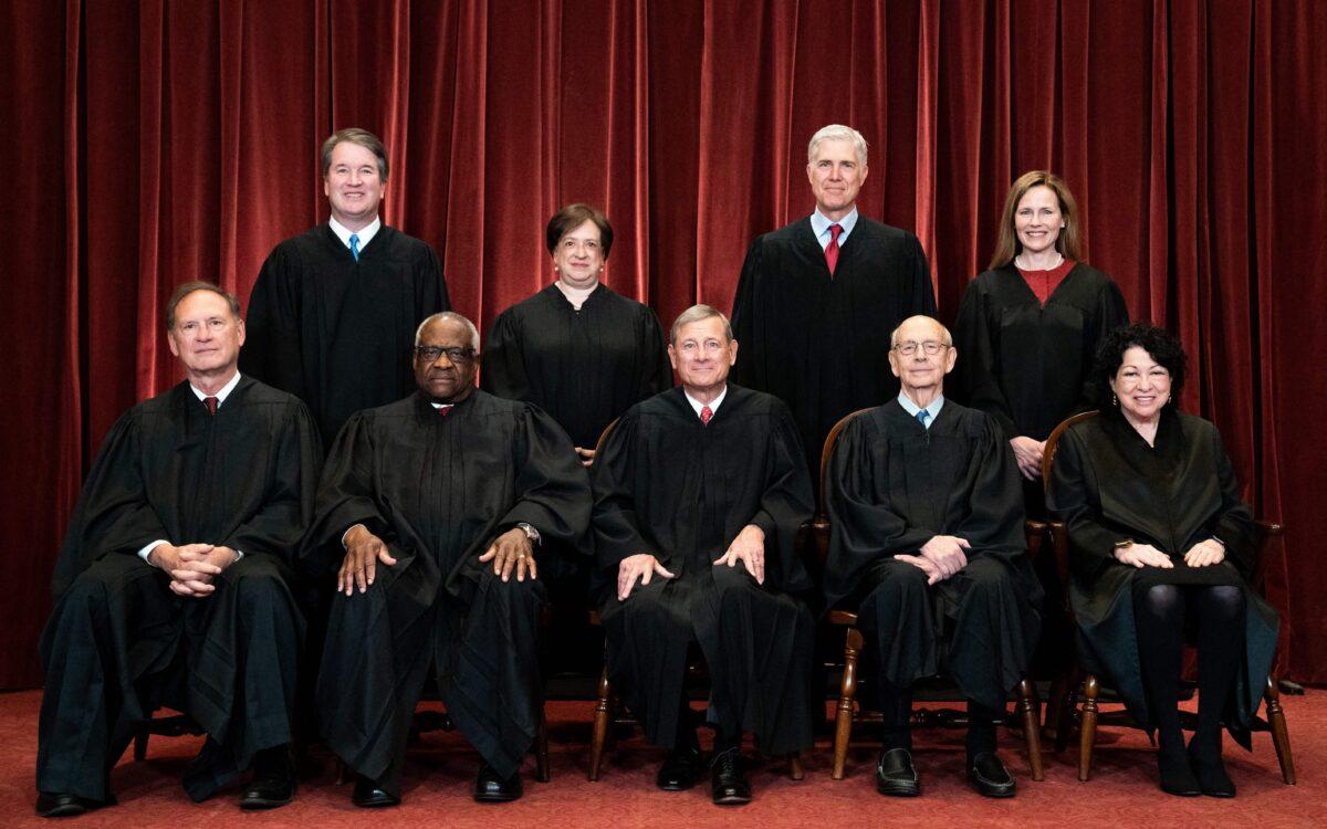 Members of the Supreme Court pose for a group photo in Washington on April 23, 2021. (Front, L–R) Justices Samuel Alito and Clarence Thomas, Chief Justice John Roberts, and Justices Stephen Breyer and Sonia Sotomayor. (Back L–R) Justices Brett Kavanaugh, Elena Kagan, Neil Gorsuch, and Amy Coney Barrett. (Erin Schaff/Getty Images)