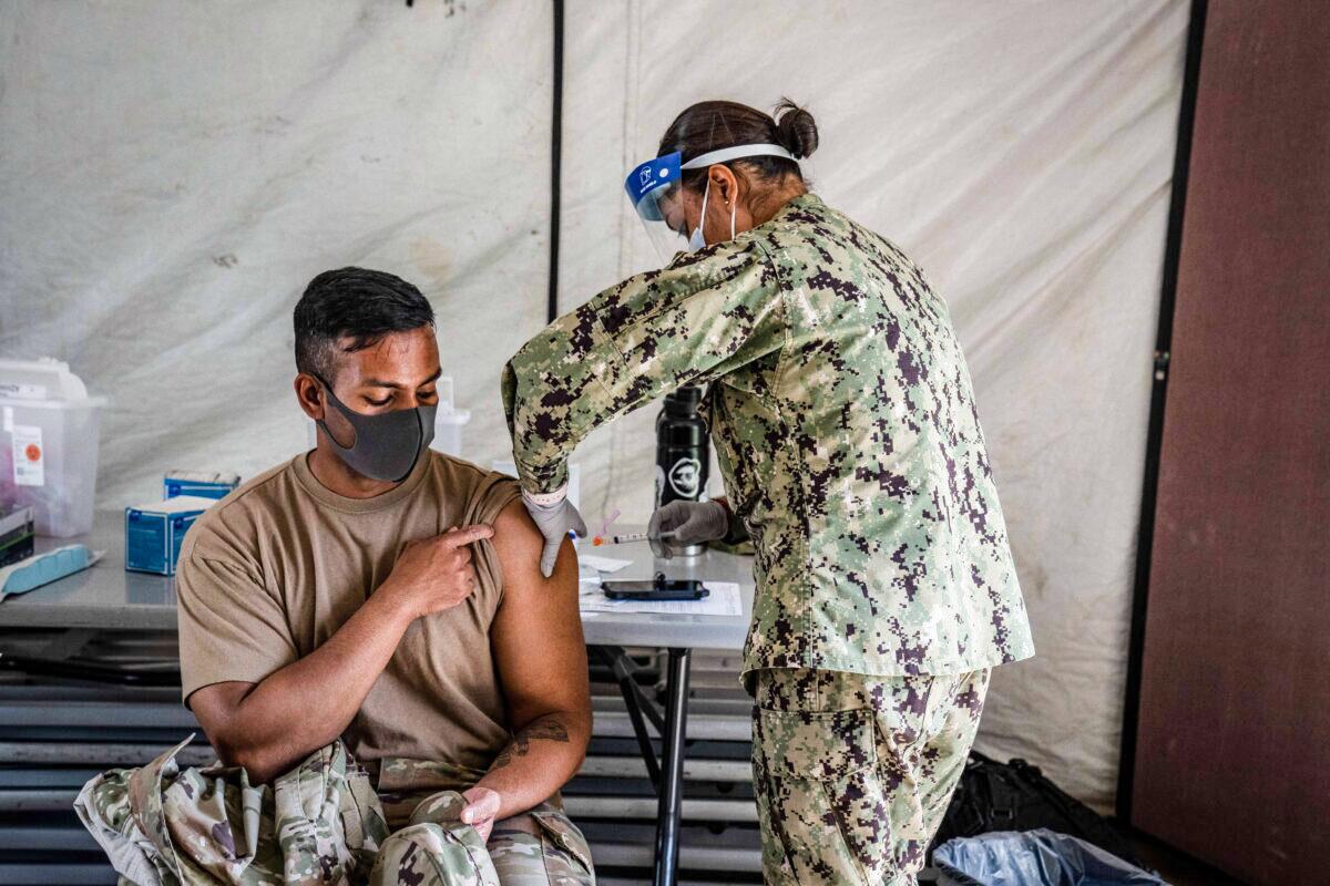 A member of the U.S. military receives the Moderna COVID-19 vaccine at Camp Foster in Ginowan, Japan, on April 28, 2021. (Carl Court/Getty Images)