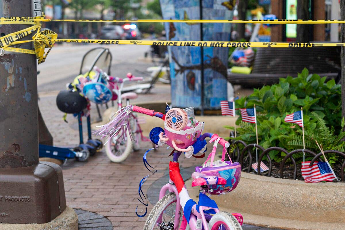 Police crime tape is seen around the area where children's bicycles and baby strollers stand near the scene of the Fourth of July parade shooting in Highland Park, Ill., on July 4, 2022. (Youngrae Kim/AFP via Getty Images)