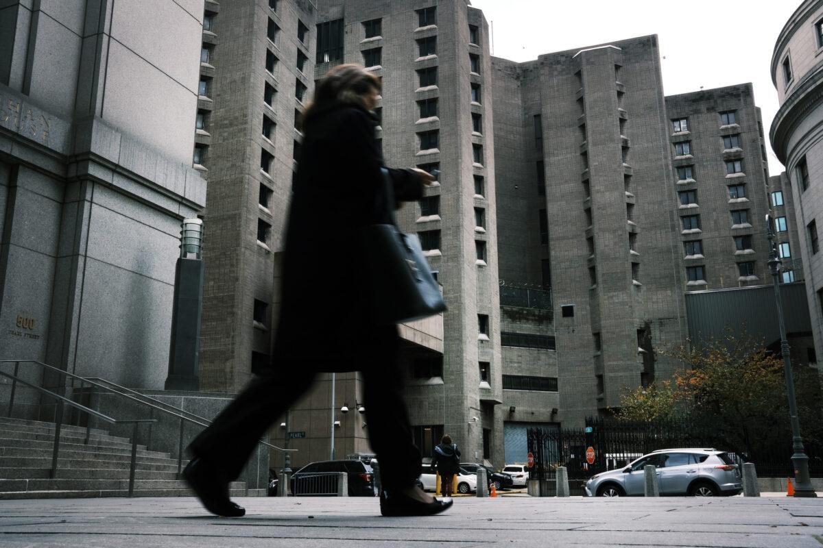 A woman walks by the Metropolitan Correctional Center, which is operated by the Federal Bureau of Prisons, stands in lower Manhattan in New York City, on Nov. 19, 2019. (Spencer Platt/Getty Images)