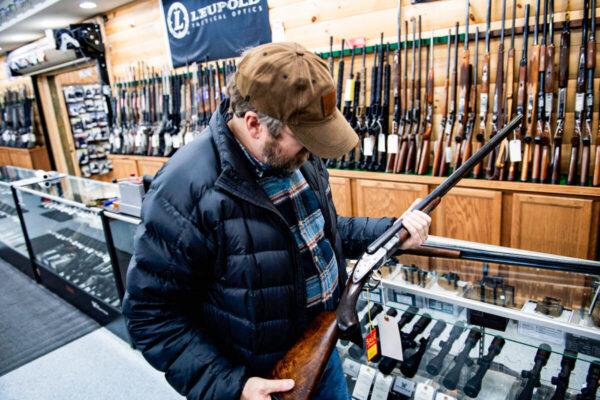 A customer looks at a firearm at a gun shop in Ohio in a file image. (Brendan Smialowski/AFP via Getty Images)