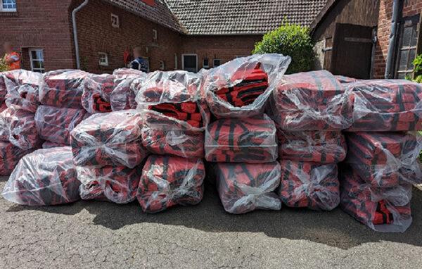 Hundreds of lifejackets discovered by investigators are piled up outside an address in the city of Osnabruck in Germany on July 5, 2022. (National Crime Agency/PA)