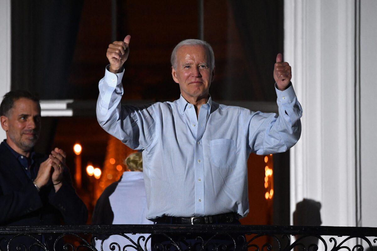 President Joe Biden gives two thumbs up from a balcony of the White House as his son Hunter Biden (L) looks on during the 4th of July fireworks in Washington on July 4, 2022. (Nicholas Kamm/AFP via Getty Images)