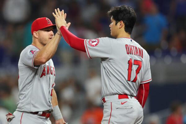Mike Trout #27 of the Los Angeles Angels high fives Shohei Ohtani #17 after defeating the Miami Marlins 5-2 at loanDepot Park, in Miami, on July 06, 2022. (Michael Reaves/Getty Images)