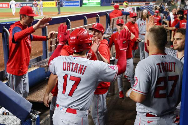 Shohei Ohtani #17 of the Los Angeles Angels high fives teammates after scoring a run in the seventh inning against the Miami Marlins at loanDepot Park, in Miami, on July 06, 2022. (Michael Reaves/Getty Images)