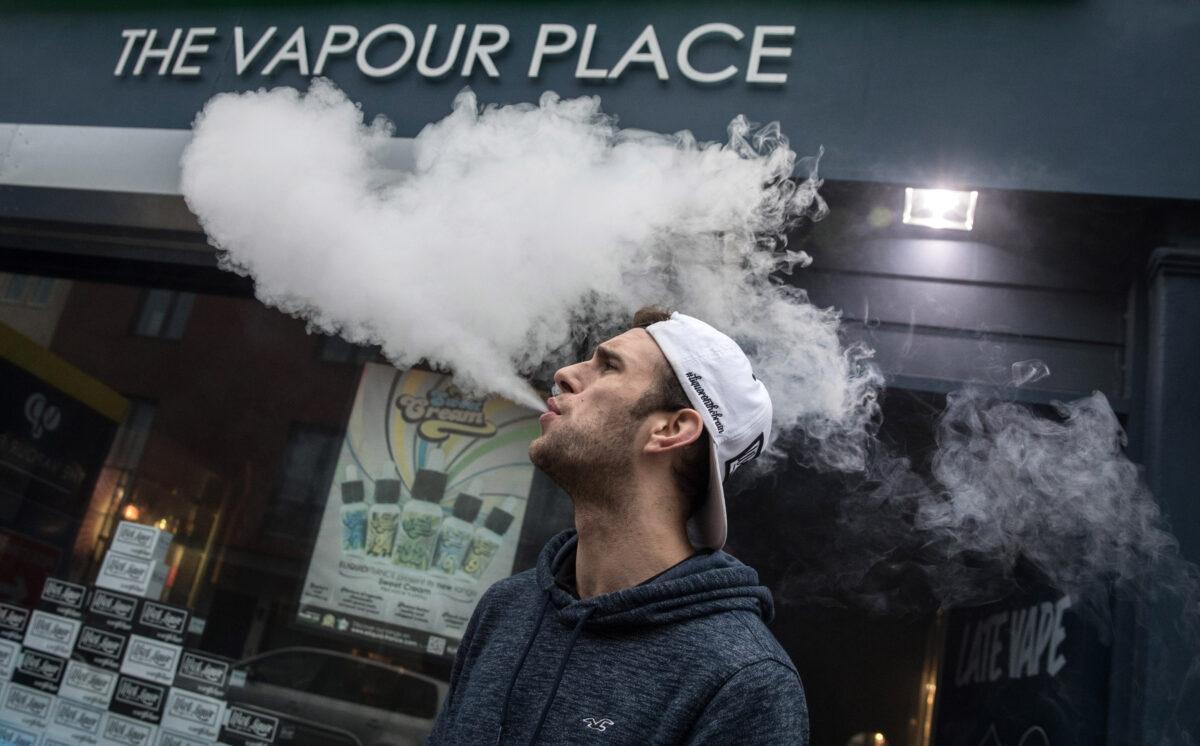 Mitchell Baker who works at the Vapour Place, a vaping shop in Bedminster, exhales vapour produced by an e-cigarette in Bristol, England, on Dec. 30, 2016. (Matt Cardy/Getty Images)