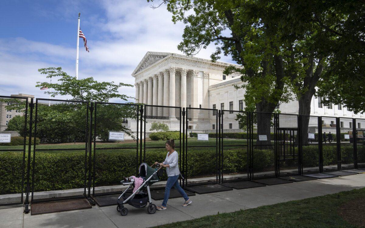 A woman pushes a stroller as she walks by the U.S. Supreme Court in Washington on May 11, 2022. (Drew Angerer/Getty Images)