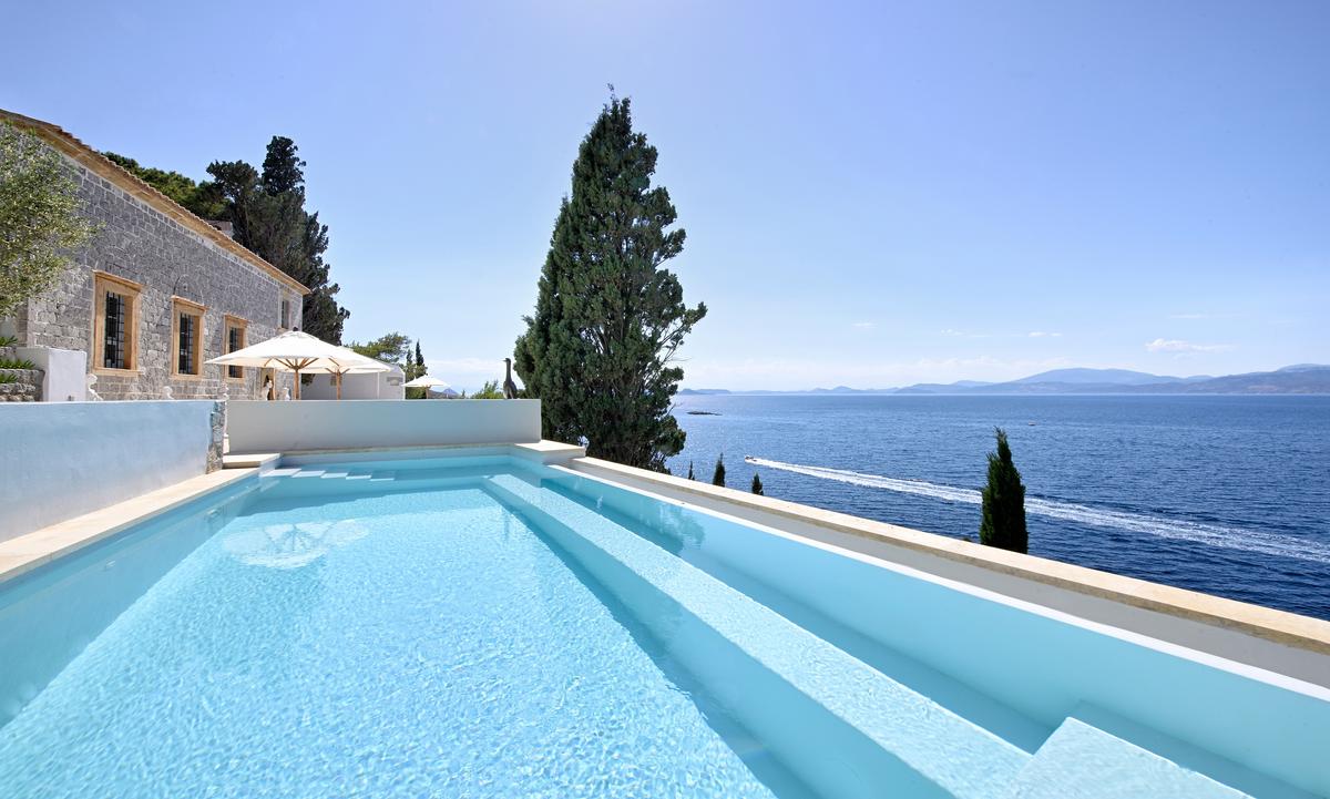 The estate’s infinity pool is the ultimate accent to a remarkable Greek property. It is equally ideal for daytime family events or a moonlit swim. (Courtesy of Greece Sotheby's International Realty)