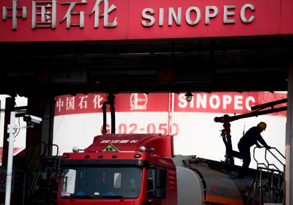 A man works at a Sinopec filling station in Shanghai, China, on March 22, 2018. (Johannes Eisele/AFP via Getty Images)