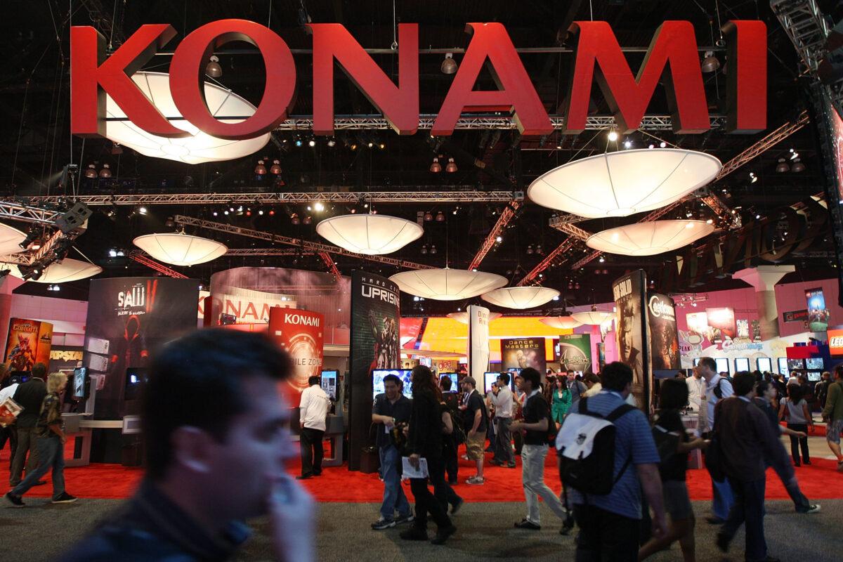 People walk near the Konami exhibit at the annual Electronic Entertainment Expo (E3) at the Los Angeles Convention Center in Calif., on June 16, 2010. (David McNew/Getty Images)
