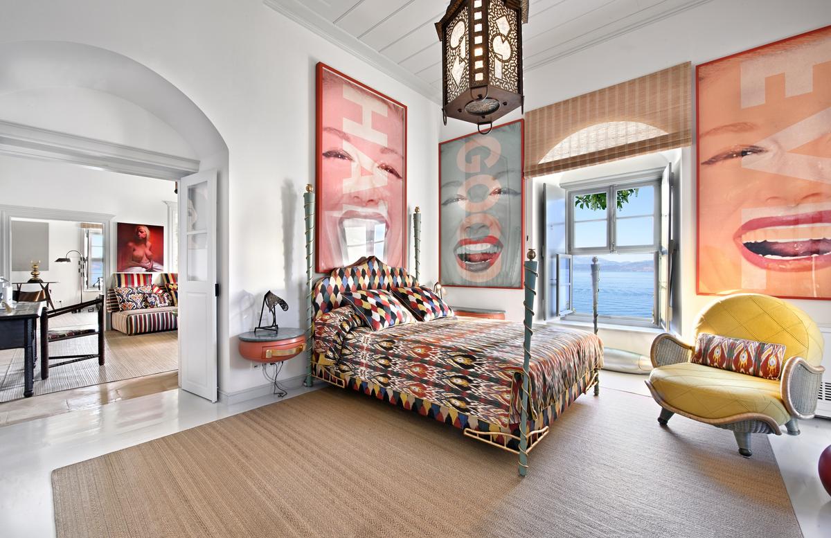 The main villa’s welcoming master bedroom provides easy access to the home’s library, sitting room, and other spaces. (Courtesy of Greece Sotheby's International Realty)