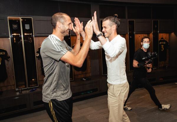 LAFC's latest signees, Giorgio Chiellini (L) and Gareth Bale greet one another inside the clubhouse at Banc of California Stadium, in Los Angeles, on July 08, 2022.