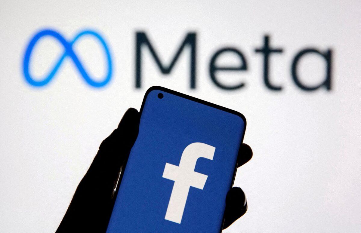 A smartphone with Facebook's logo is seen with new rebrand logo Meta, in this illustration taken on Oct. 28, 2021. (Dado Ruvic via Reuters)
