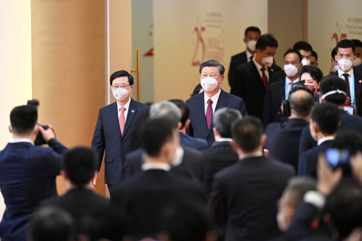 China's President Xi Jinping (C) arrives with Hong Kong's incoming Chief Executive John Lee (L) for Lee's swearing in ceremony and to inaugurate the city's new government in Hong Kong on July 1, 2022, the 25th anniversary of the city's handover from Britain to China. (Selim Chtayti/Pool/AFP via Getty Images)