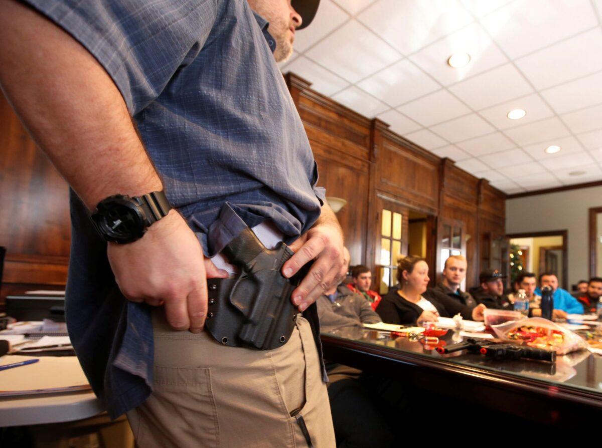 Damon Thueson shows a holster at a gun concealed carry permit class put on by "USA Firearms Training" in Provo, Utah, on Dec. 19, 2015. (George Frey/Getty Images)