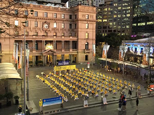 Falun Gong practitioners in Sydney held a rally at the Customs House Plaza to commemorate the 23rd anniversary of the July 20 anti-persecution movement. The picture shows the candlelight memorial service. (Ling Xiao/The Epoch Times)