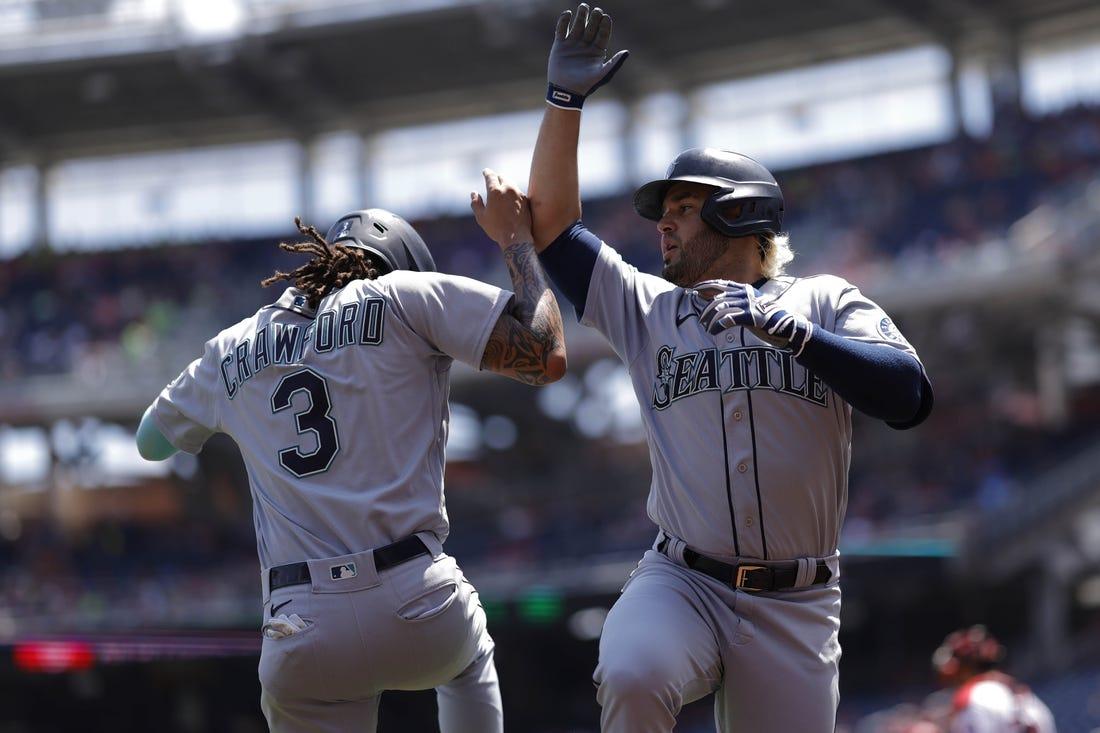 Jul 13, 2022; Washington, District of Columbia, USA; Seattle Mariners third baseman Eugenio Suarez (28) celebrates with Mariners shortstop J.P. Crawford (3) after hitting a three run home run against the Washington Nationals during the first inning at Nationals Park. (Geoff Burke-USA TODAY Sports)