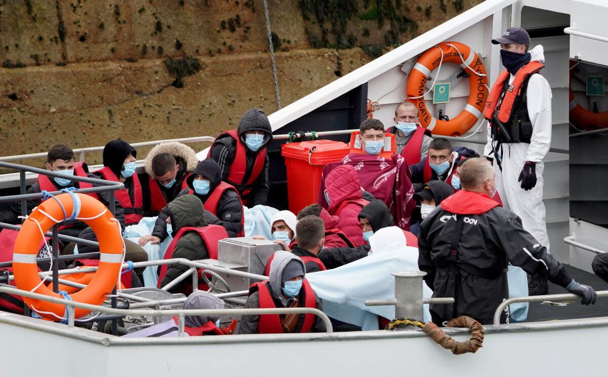 A group of people thought to be migrants are brought into Dover. (Gareth Fuller/PA)