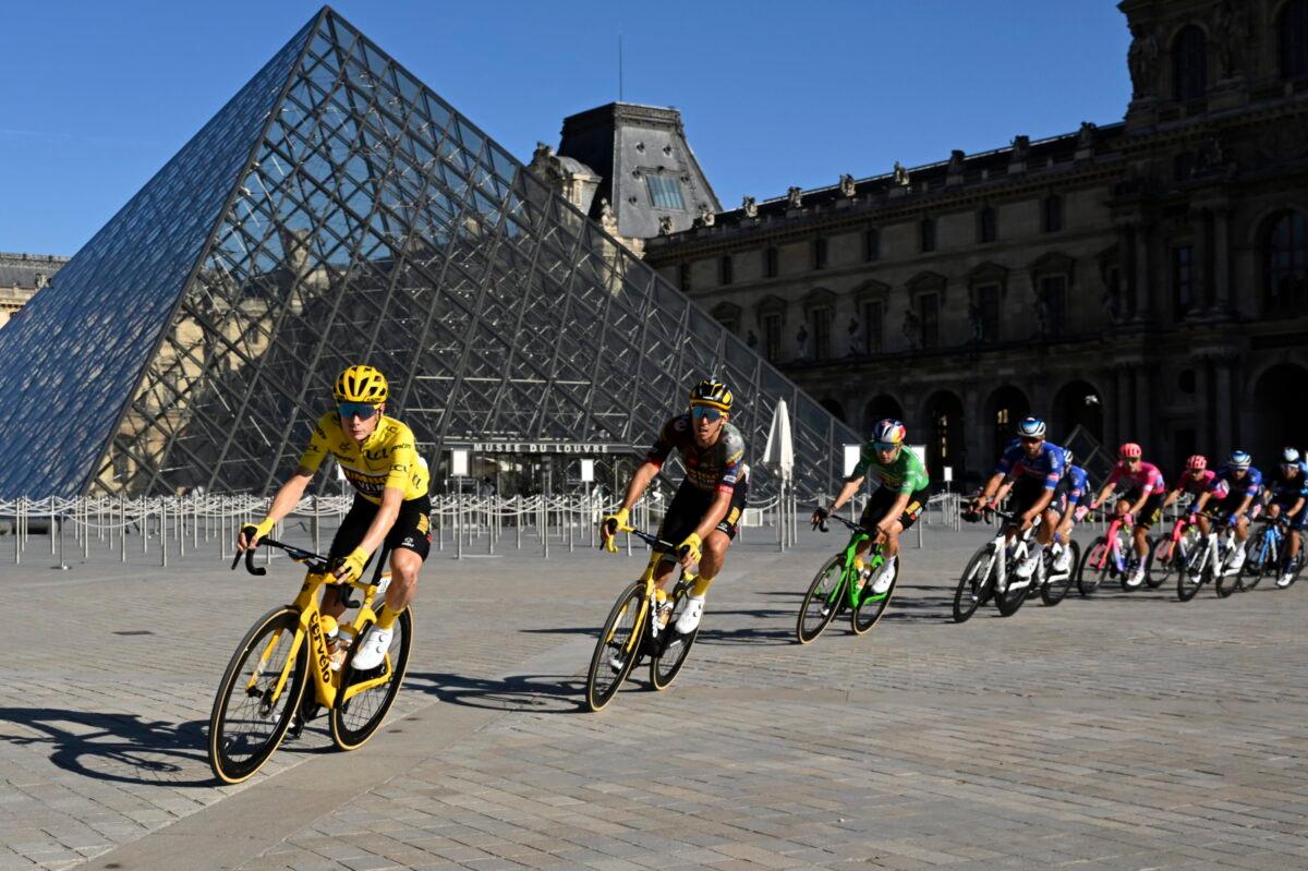 The pack with Denmark's Jonas Vingegaard, wearing the overall leader's yellow jersey, passes the Louvre Museum during the twenty-first stage of the Tour de France cycling race over 116 kilometers (72 miles) with start in Paris la Defense Arena and finish on the Champs Elysees in Paris on July 24, 2022. (Bertrand Guay/Pool via AP)
