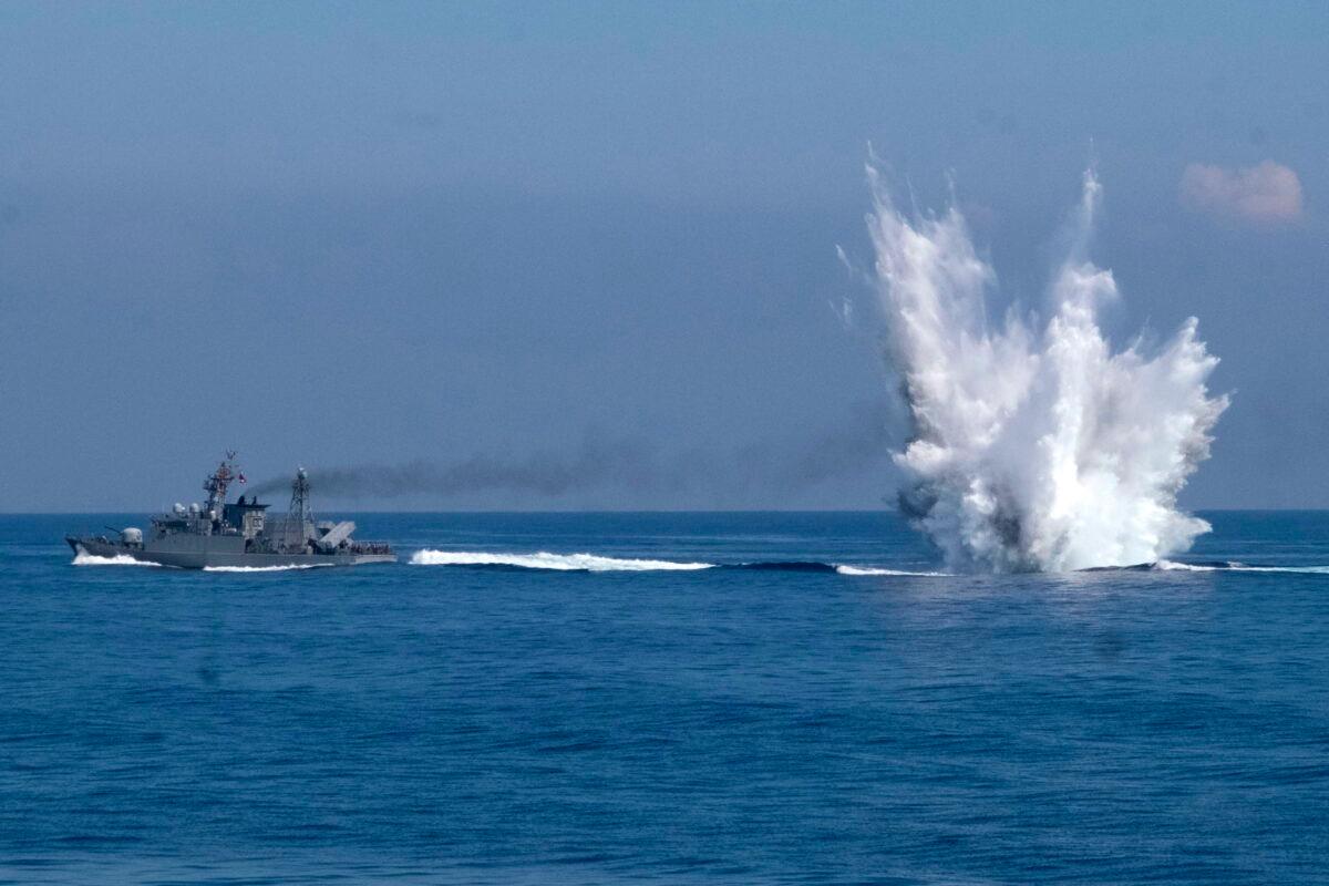 A Ching Chiang class patrol ship fires off depth charges underwater as part of a navy demonstration in Taiwan's annual Han Kuang exercises off the island's eastern coast near the city of Yilan, Taiwan, on July 26, 2022. (Huizhong Wu/AP Photo)