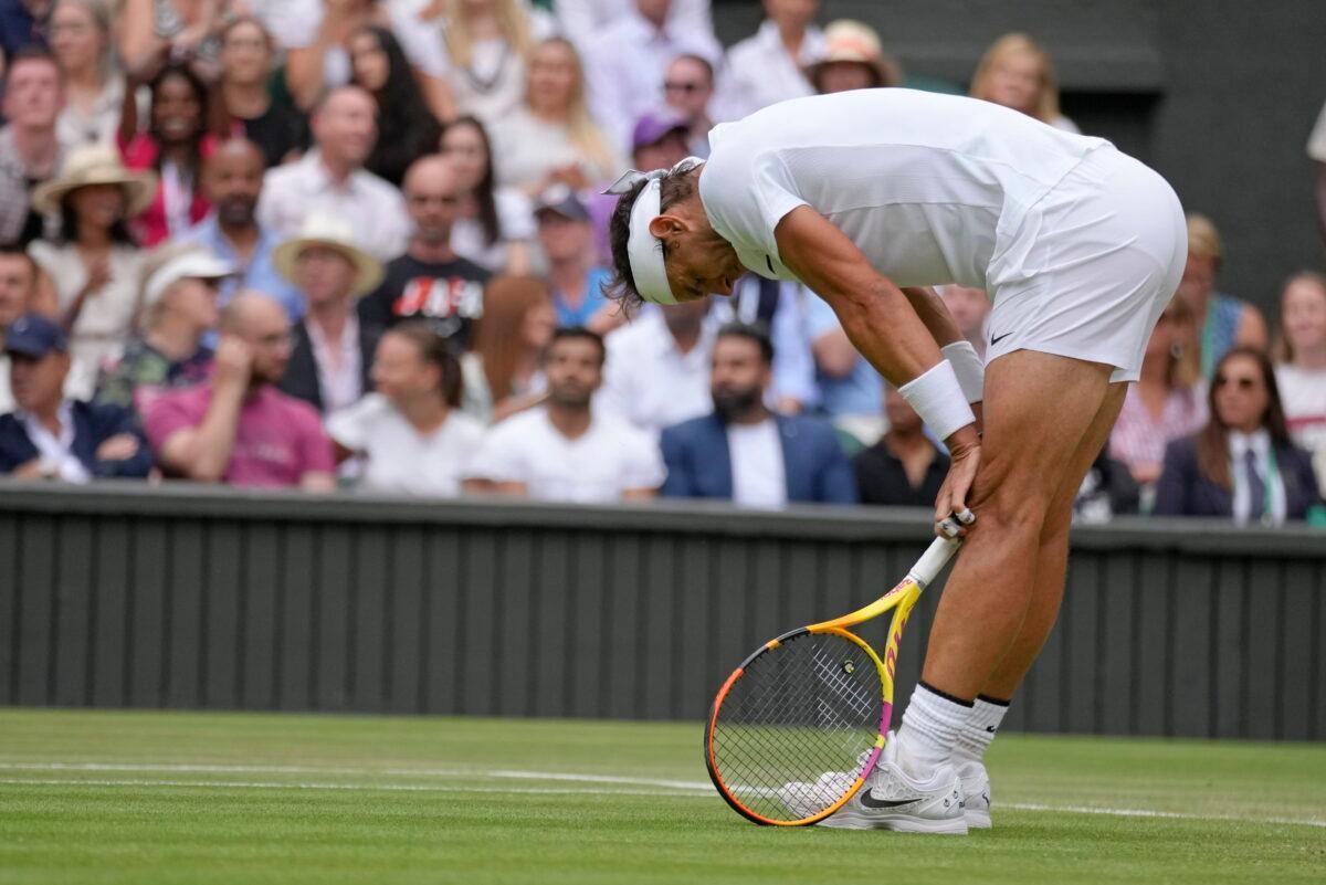 Spain's Rafael Nadal reacts after losing a point as he plays Taylor Fritz of the United States in a men's singles quarterfinal match on day ten of the Wimbledon tennis championships in London on July 6, 2022. (Kirsty Wigglesworth/AP Photo)