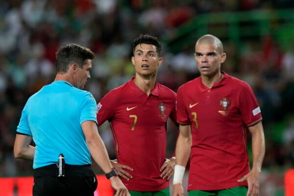 Portugal's Cristiano Ronaldo and his teammate Pepe look to the referee Matej Jug during the UEFA Nations League soccer match between Portugal and the Czech Republic, at the Jose Alvalade Stadium in Lisbon, Portugal, on June 9, 2022. (Armando Franca/AP Photo)