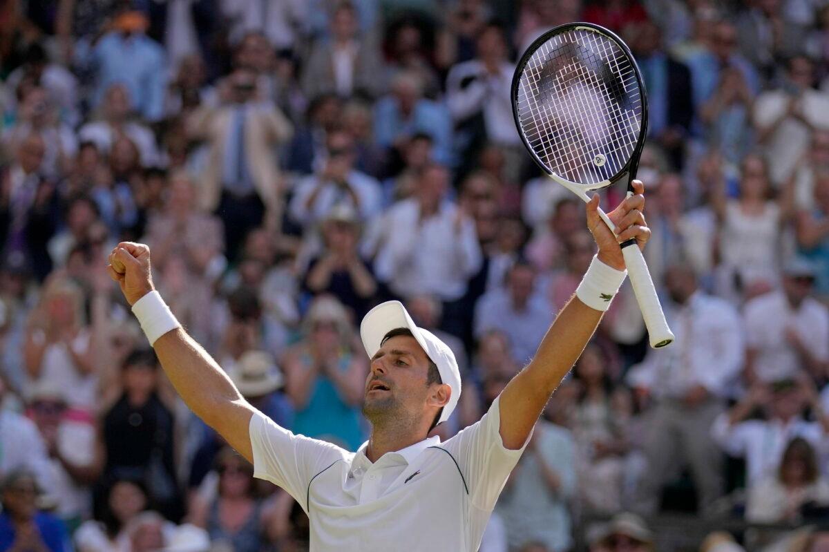 Serbia's Novak Djokovic celebrates after beating Australia's Nick Kyrgios to win the final of the men's singles on day fourteen of the Wimbledon tennis championships in London on July 10, 2022. (Alastair Grant/AP Photo)