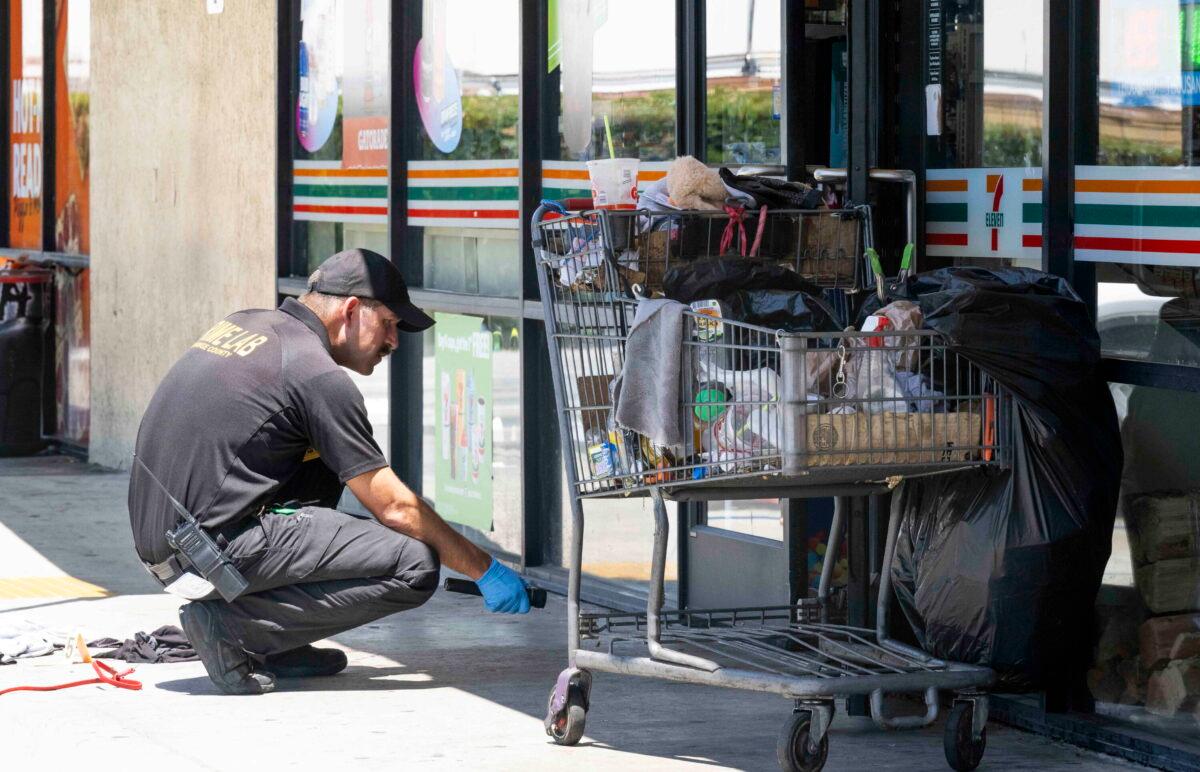 Officials investigate after officers found two victims with gunshot wounds following a robbery at a 7-Eleven in La Habra, Calif., on July 11, 2022. (Paul Bersebach/The Orange County Register via AP)