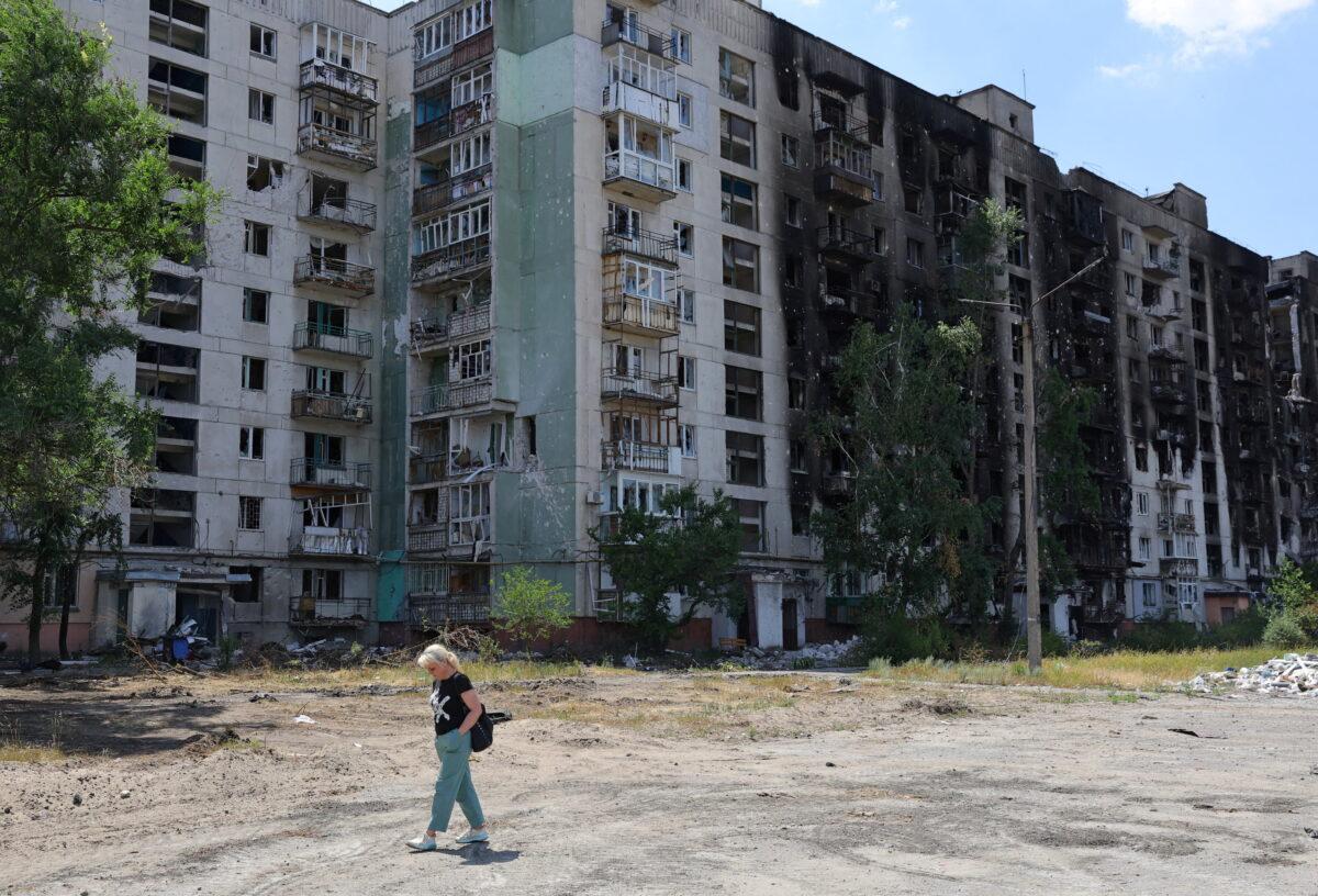 A resident walks past an apartment building heavily damaged during the Ukraine-Russia conflict in the city of Sievierodonetsk in the Luhansk Region, Ukraine, on July 1, 2022. (Alexander Ermochenko/Reuters)