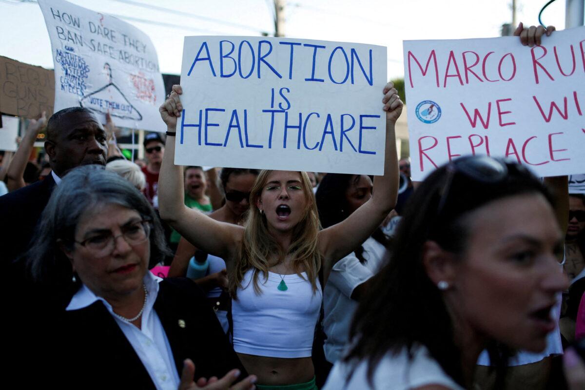 A pro-abortion protester holds a sign as she demonstrates in Miami after the U.S. Supreme Court overturned Roe v. Wade on June 24, 2022. (Marco Bello/Reuters)
