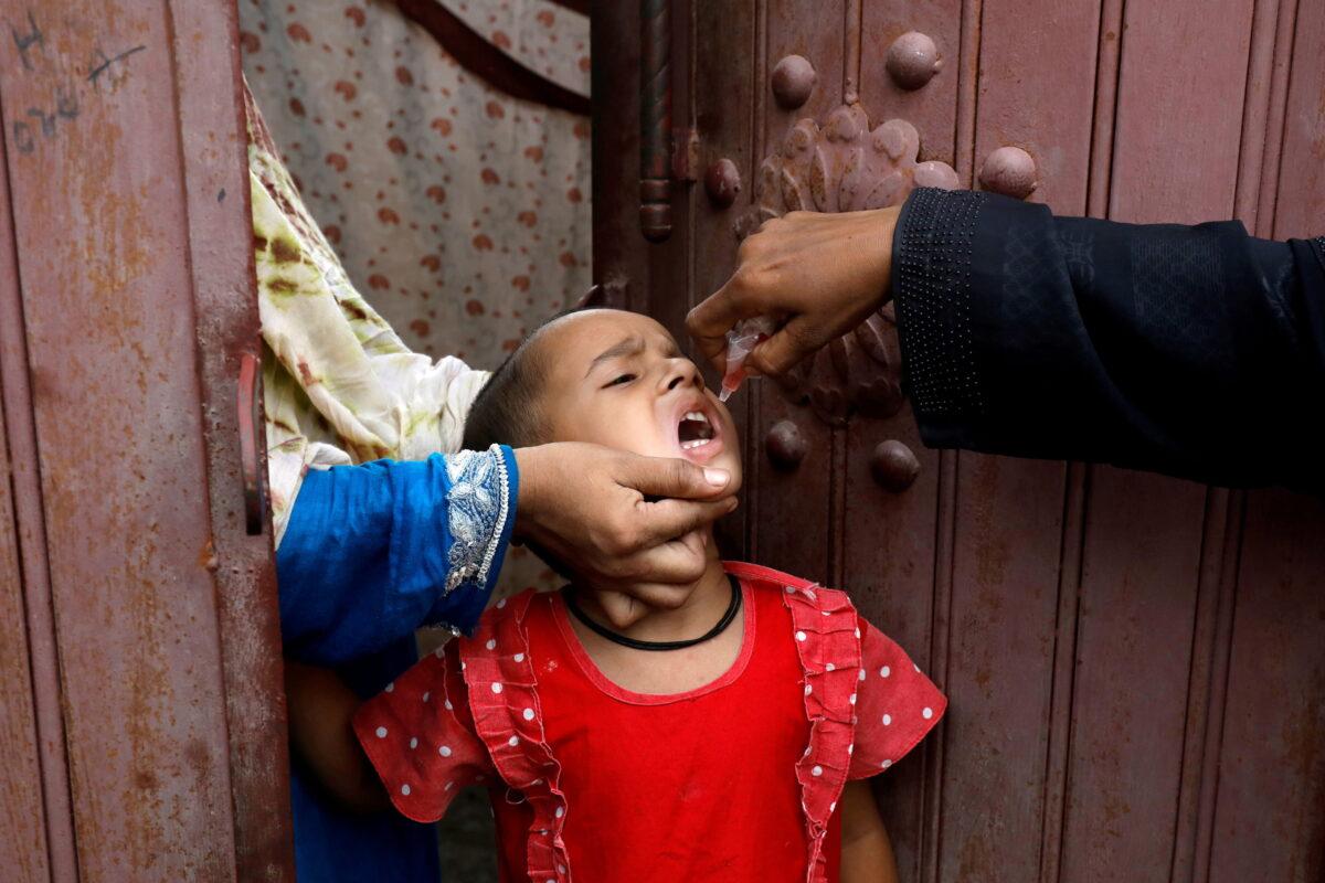 A girl receives polio vaccine drops during an anti-polio campaign in a low-income neighborhood as the spread of COVID-19 continues in Karachi, Pakistan, on July 20, 2020. (Akhtar Soomro/Reuters)