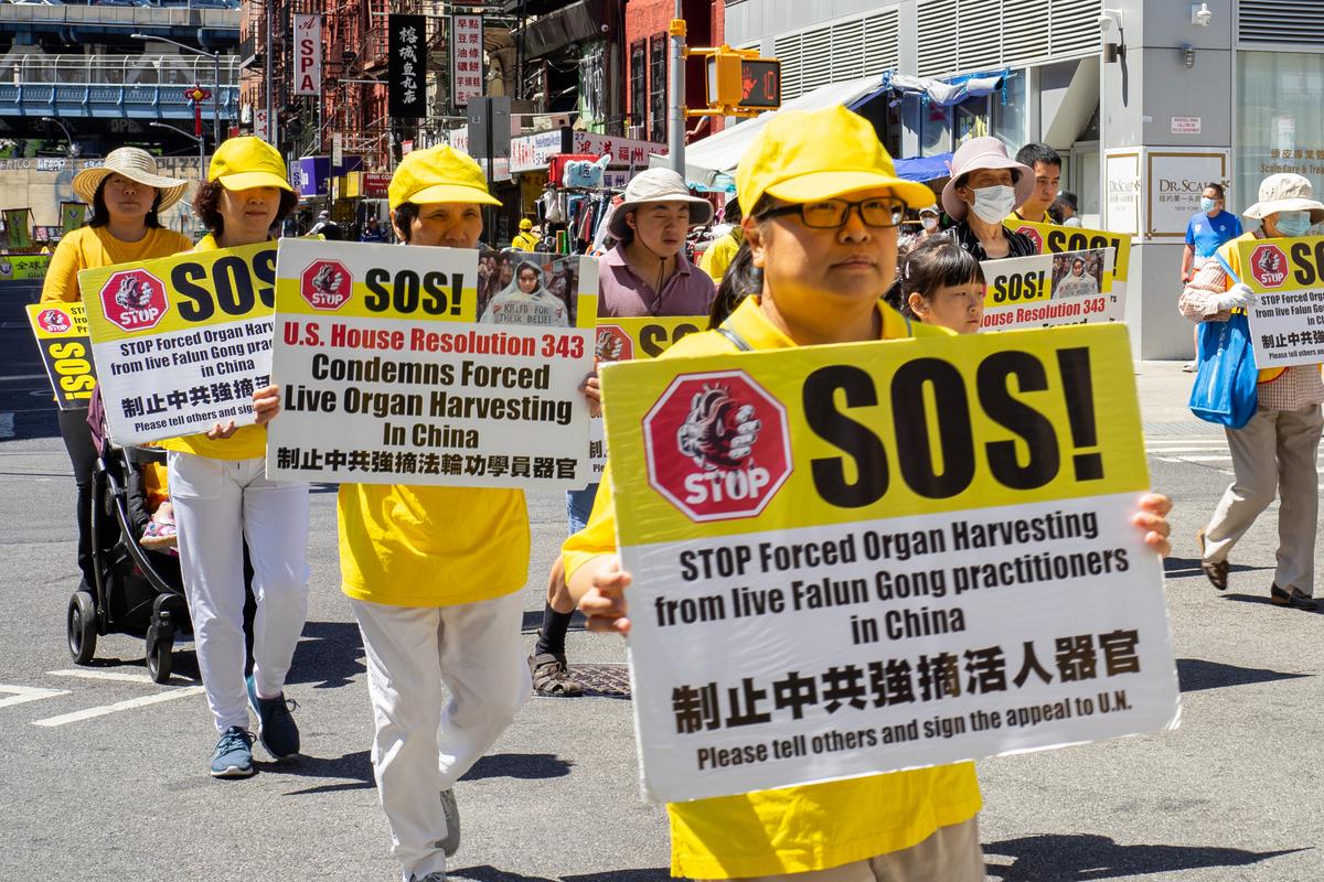 Falun Gong practitioners take part in a parade to commemorate the 23rd anniversary of the persecution of the spiritual discipline in China, in New York's Chinatown on July 10, 2022. (Chung I Ho/The Epoch Times)