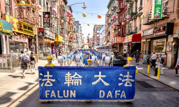 Falun Gong practitioners take part in a parade to commemorate the 23rd anniversary of the persecution of the spiritual discipline in China in New York's Chinatown on July 10, 2022. (Samira Bouaou/The Epoch Times)