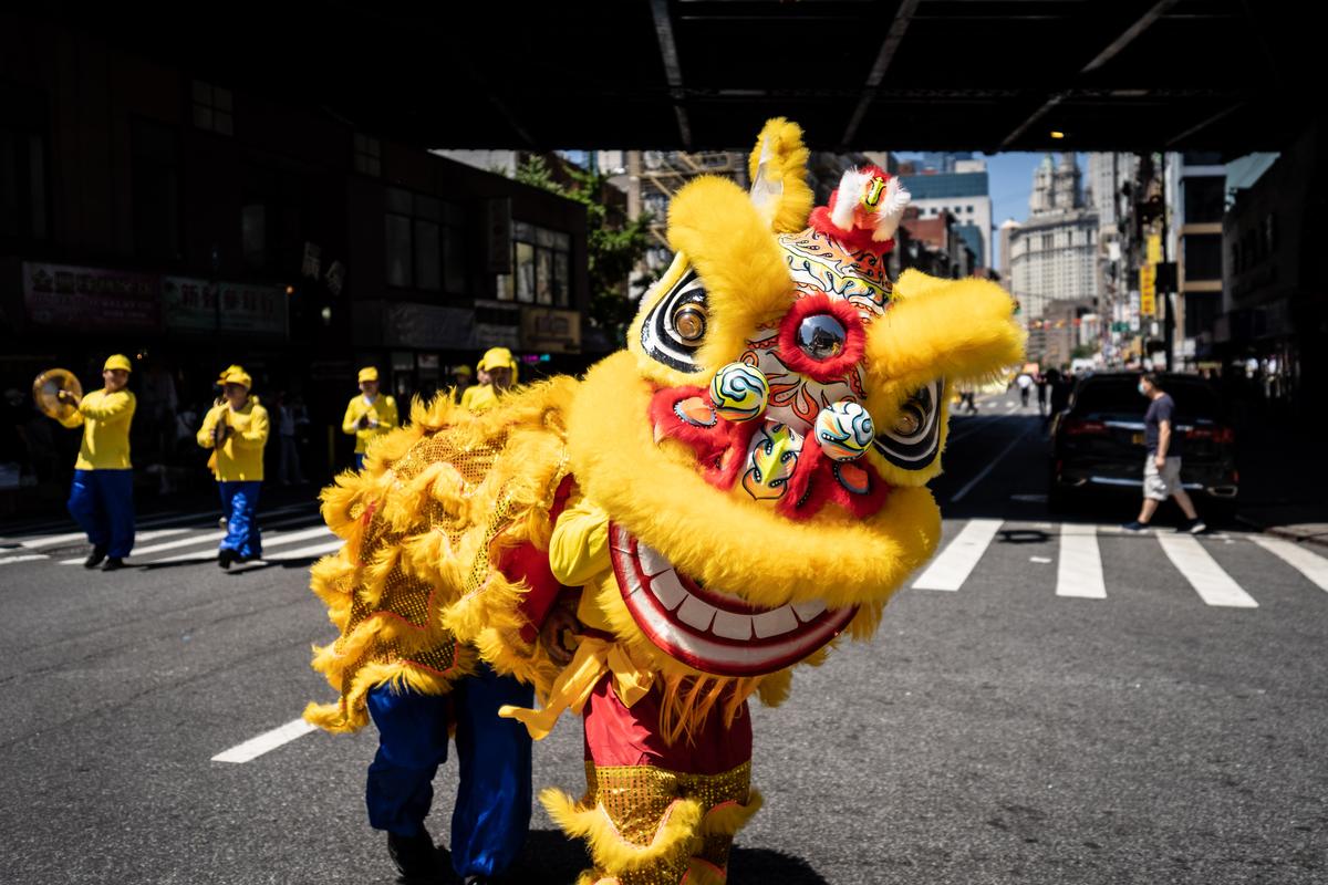 Falun Gong practitioners take part in a parade to commemorate the 23rd anniversary of the persecution of the spiritual discipline in China, in New York's Chinatown on July 10, 2022. (Samira Bouaou/The Epoch Times)