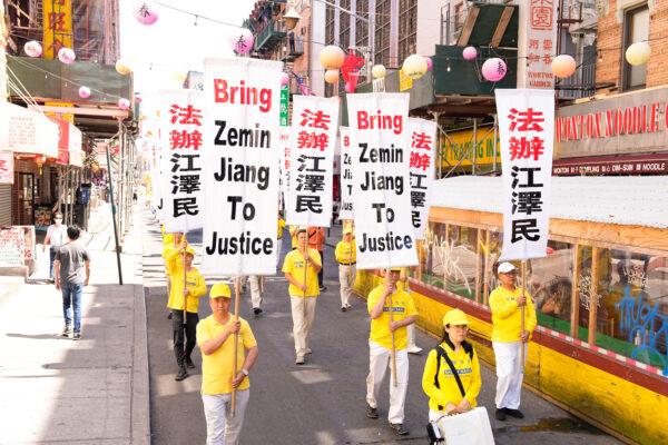  Falun Gong practitioners take part in a parade to commemorate the 23rd anniversary of the persecution of the spiritual discipline in China, in New York's Chinatown on July 10, 2022. (Larry Dye/The Epoch Times)