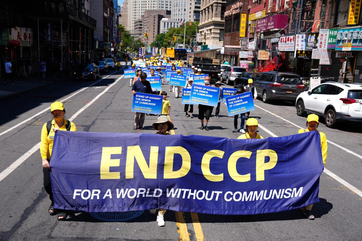 Falun Gong practitioners take part in a parade commemorating the 23rd anniversary of the persecution of the spiritual discipline in China, in New York's Chinatown on July 10, 2022. (Larry Dye/The Epoch Times)