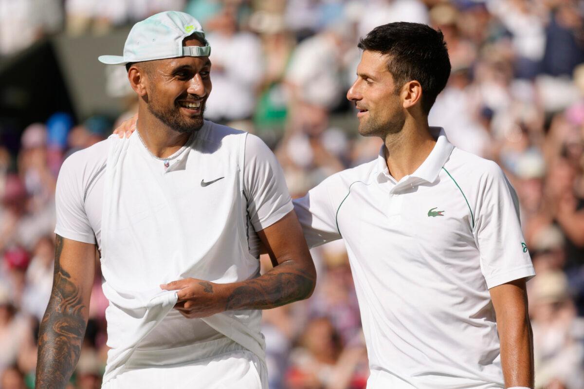 Serbia's Novak Djokovic (R) celebrates with Australia's Nick Kyrgios after winning the Wimbledon final in London on July 10, 2022. (Kirsty Wigglesworth/AP Photo)
