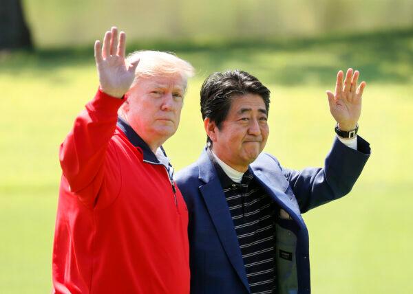 President Donald Trump and Japanese Prime Minister Shinzo Abe wave on the way to play golf at Mobara Country Club in Chiba, Japan, on May 26, 2019. (Kimimasa Mayama/Pool/Getty Images)