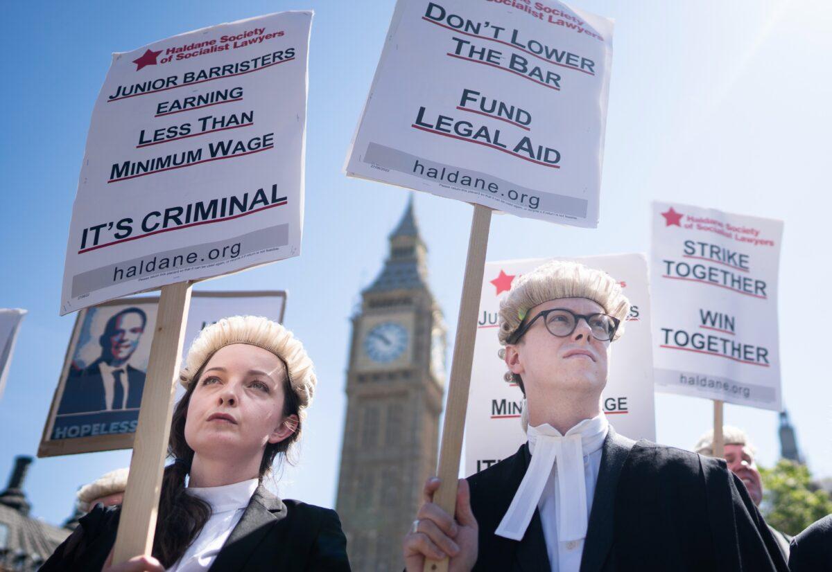Criminal defence barristers rally in support of the ongoing Criminal Bar Association (CBA) action, outside the Houses of Parliament, in London, on July 11, 2022. (Stefan Rousseau/PA Media)