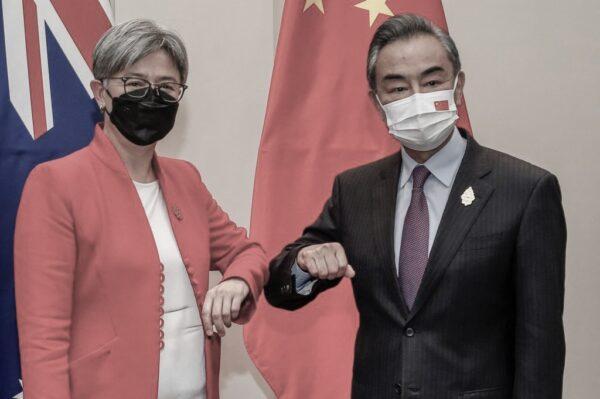 Australia's Foreign Minister Penny Wong (L) bumps elbows with China's Foreign Minister Wang Yi during their bilateral meeting on the sidelines of the G20 Foreign Ministers Meeting in Nusa Dua on Indonesia's resort island of Bali on July 8, 2022. (Johannes P. Christo/POOL/AFP via Getty Images)