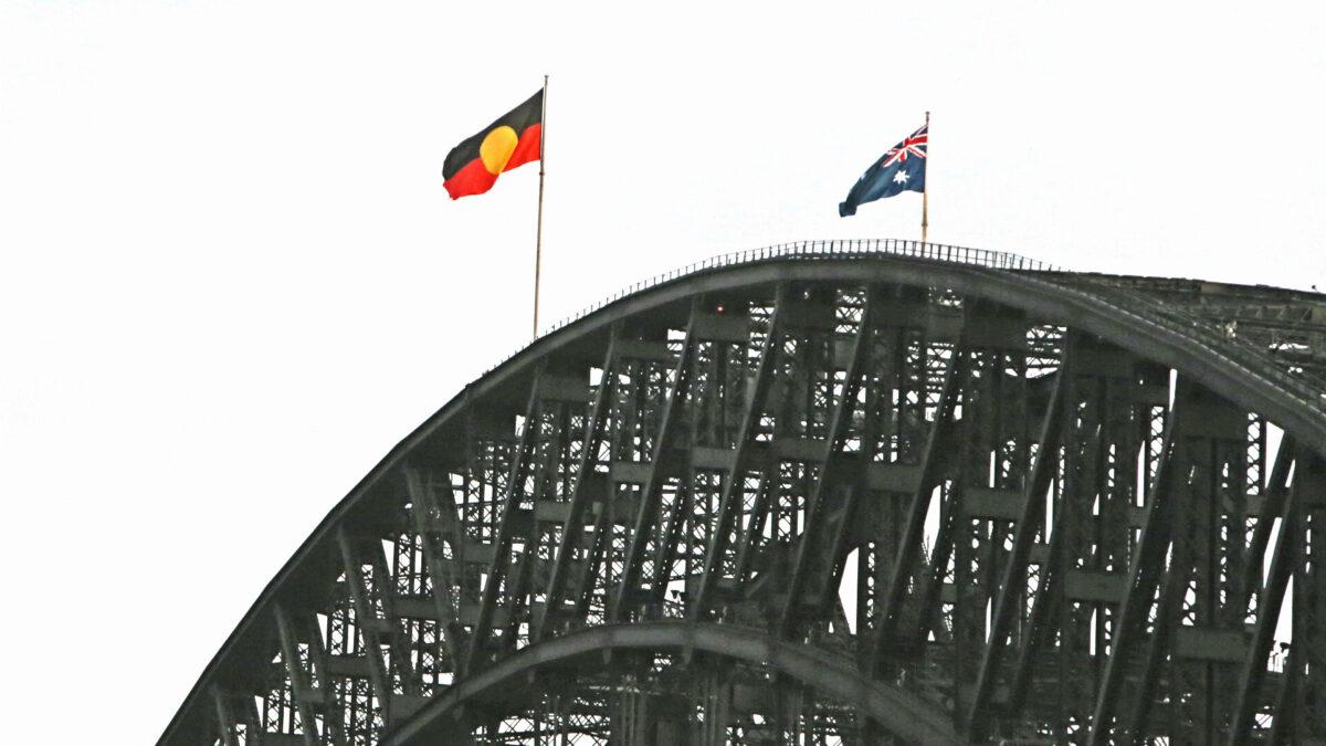  The Aboriginal flag is seen alongside the Australian flag on top of the Harbour Bridge in Sydney, Australia, on Jan. 26, 2022. (Lisa Maree Williams/Getty Images)