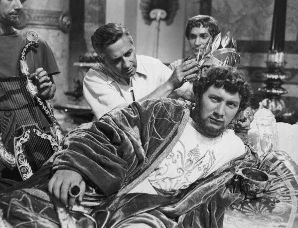Director and producer Mervyn LeRoy puts a crown on actor Peter Ustinov during the filming of LeRoy's film "Quo Vadis." Ustinov is dressed in costume as the Roman Emperor Nero. (Hulton Archive/Getty Images)