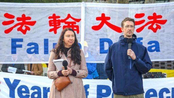 Australian Falun Gong practitioners Emma (L) and Jarrod Hall (R) speak at a Falun Dafa rally in Melbourne, Australia, on July 9, 2022. (Chen Ming/Epoch Times)