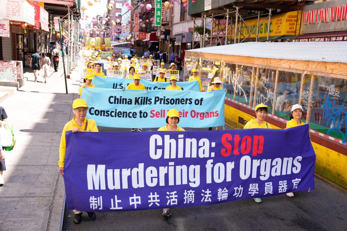 Falun Gong practitioners take part in a parade to commemorate the 23rd anniversary of the persecution of the spiritual discipline in China, in New York's Chinatown, on July 10, 2022. (Larry Dye/The Epoch Times)