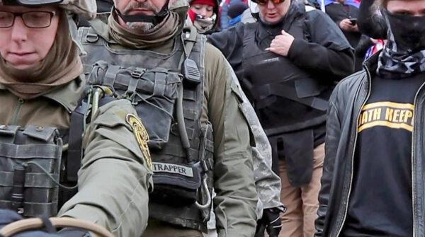 Oath Keepers defendant Jessica Watkins (front left) moves down the steps of the U.S. Capitol on Jan. 6, 2021. (The Real Story of Jan. 6/Epoch TV)