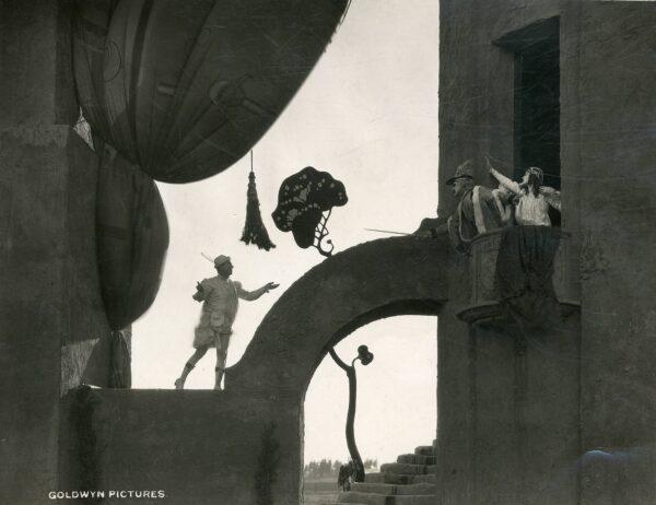 scene from “Doubling for Romeo,” a 1921 American silent comedy co-written by and starring Will Rogers. (Public Domain)